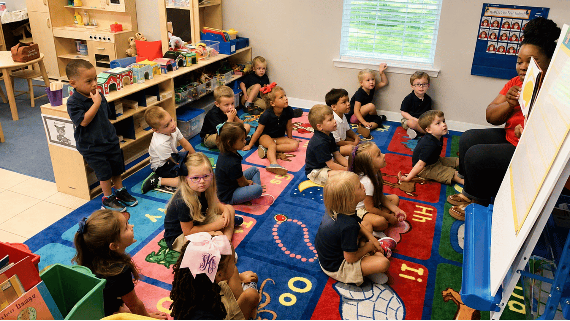 A teacher leading circle time with preschoolers at KinderKids Learning Center